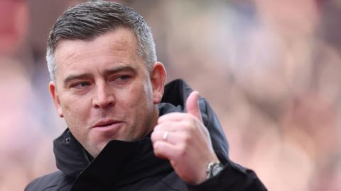 Stoke City boss Steven Schumacher gives the thumbs-up gesture