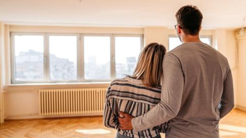 Young couple looking at new home - stock image