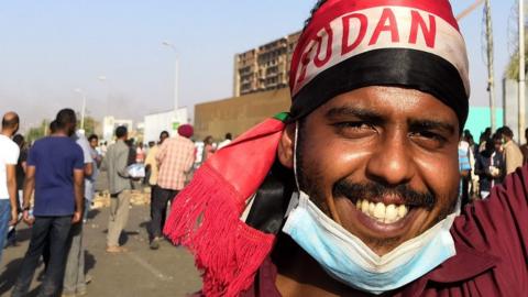 A Sudanese protester gestures during a rally in front of the military headquarters in the capital Khartoum on April 9, 2019.