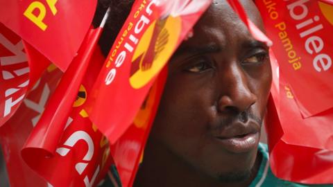 A supporter of President Uhuru Kenyatta wears campaign flags on his head in Nairobi, 23 October