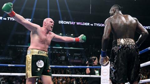 Tyson Fury (left) fighting Deontay Wilder (right)