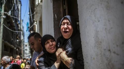 Grandmother of 15-year-old Mahmud Tolba, who was killed in Israeli air strike, mourns during his funeral in Al Zaitun neighborhood in the east of Gaza City