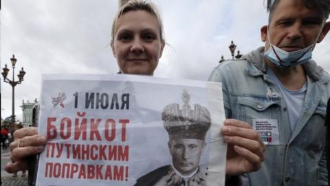 A protester in St Petersburg holds a photo of Russian President Vladimir Putin pictured as a tsar. Photo: 1 July 2020