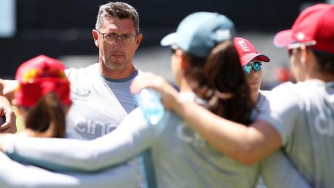 England coach Jon Lewis addresses his players during a huddle