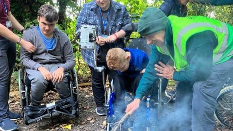 image of children and adults at the woods