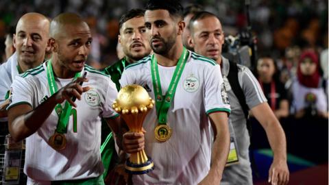 Yacine Brahimi (left) celebrates with Riyad Mahrez after winning the Africa Cup of Nations