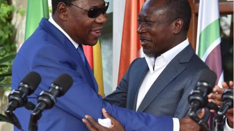 Former Beninese president Thomas Yayi Boni (L) embraces Benin's newly elected President Patrice Talon following a reconciliation meeting hosted by the Ivory Coast at the presidential residence in Abidjan, on 18 April 2016.