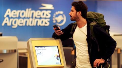 A passanger stands in front of the counter of Argentina"s flagship air carrier Aerolineas Argentinas at Buenos Aires airport, Argentina October 31, 2017.