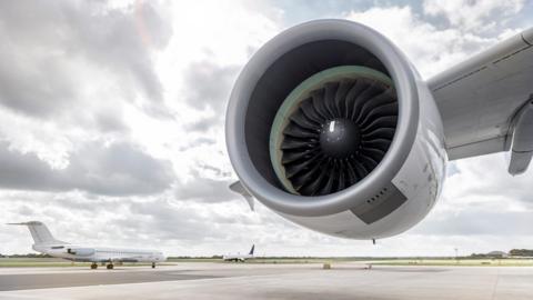 Jet engine and planes on runway