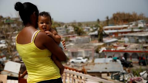 Woman surveys damage from Hurricane Maria - 30 August