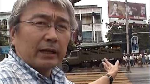 Kenji Nagai in front of Burmese military vehicles