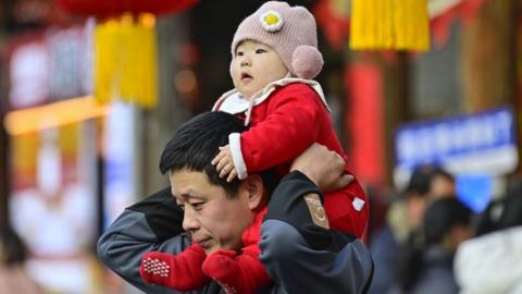 Man and child in Qingzhou city, China during Spring Festival.