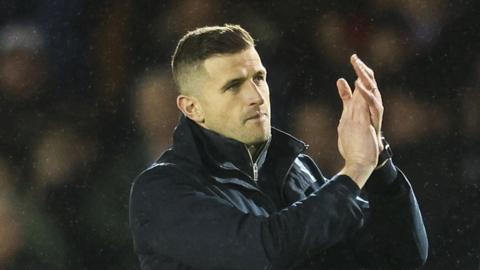 John Mousinho claps the fans after win Portsmouth's over Bolton