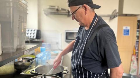 Man cooking meals for those in need