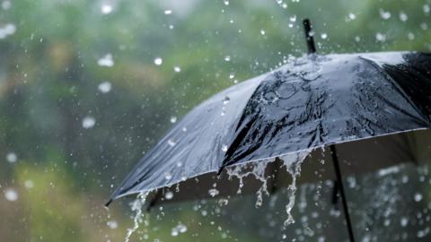 heavy rain on umbrella