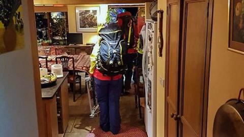 Mountain rescuers in house