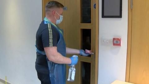 man cleaning door