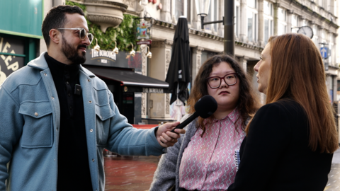 Aydan Al-Saad talking to people on a Cardiff street