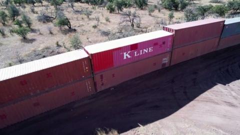 Border wall made of shipping containers