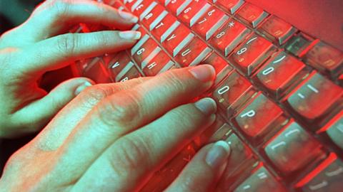 File image of hands typing on keyboard