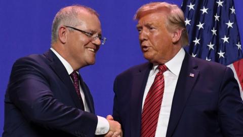 Scott Morrison shakes Donald Trumps hand during a visit to a US factory opening as part of a state visit in September 2019