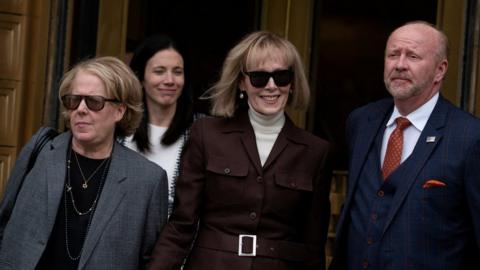 Writer E Jean Carroll (centre) exits a Manhattan Federal Court after a jury found Donald Trump guilty of sexual abuse and defamation in May
