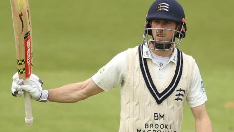 Middlesex's John Simpson celebrates his half-century