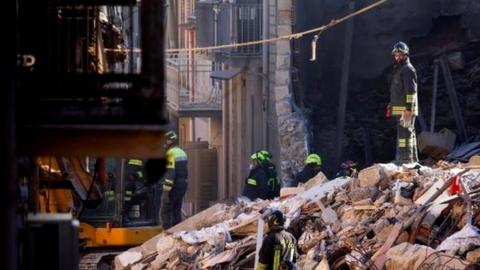 Rescuers work at the site of a gas explosion that caused several houses to collapse in Ravanusa