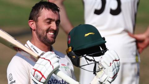 Leicestershire batter Lewis Hill celebrates a century against Gloucestershire