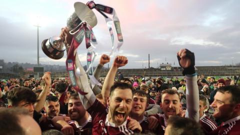 Cushendall captain Neil McManus hoists the Four Seasons Cup at Pairc Esler