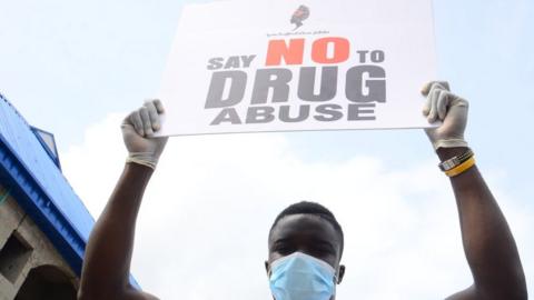 A volunteer hold placard during a one Day sensitization program in commemoration of the 2020 International Day against Drug Abuse and Illicit Trafficking in Lagos on June 26, 2020
