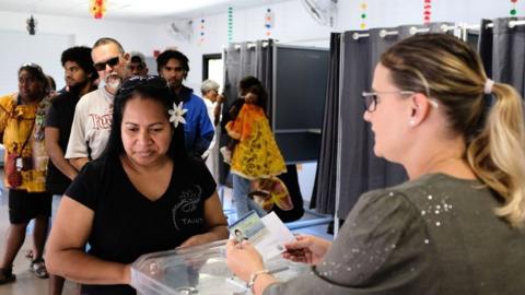 A woman casts her vote at a polling station in the referendum on independence on the French South Pacific territory of New Caledonia in Nouméa on 4 October 2020