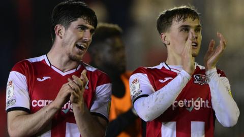 Josh Key (left) and Archie Collins applaud Exeter fans