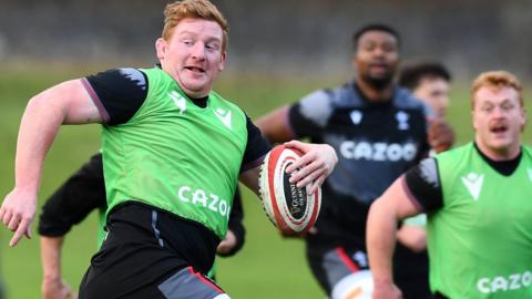 Rhys Carre (L) and Bradley Roberts (R) in Wales training with Christ Tshiunza in the background