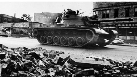 A tank patrols a Detroit street on 25 July 1967