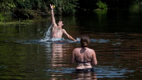 People play in a river