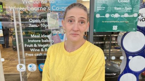 Woman standing outstide a Co-op convenience store