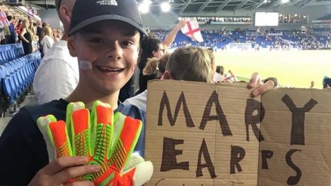Eden with Mary Earps' gloves after Norway game