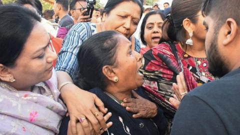 Family members react as they reach Harni Lake where a boat carrying children and teachers who were on a picnic capsized in Vadodara, India, January 18, 2024. REUTERS/Stringer NO RESALES. NO ARCHIVES