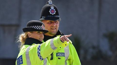 Two Greater Manchester police offers in high vis jackets