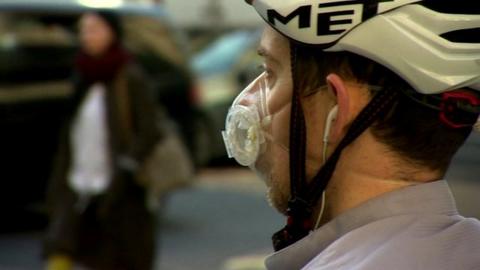 Man in cyclist helmet and face mask