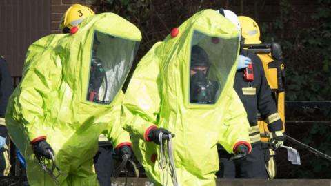 Officers in protective suits