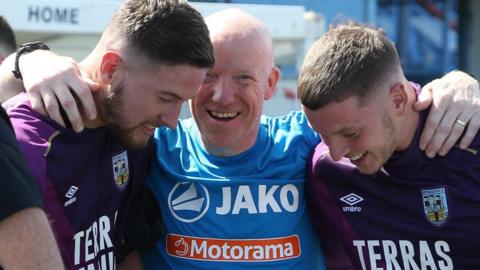 Robbie Yates pictured with Weymouth players after winning the National League South Promotion final