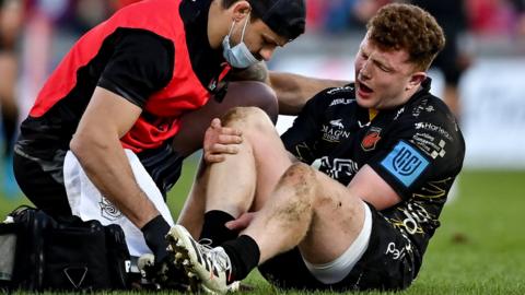 Aneurin Owen winces in pain