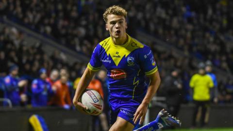 Cai Taylor-Wray of Warrington Wolves running with the ball