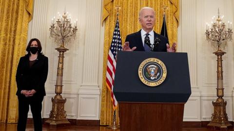 US President Joe Biden speaks, watched by Vice-President Kamala Harris