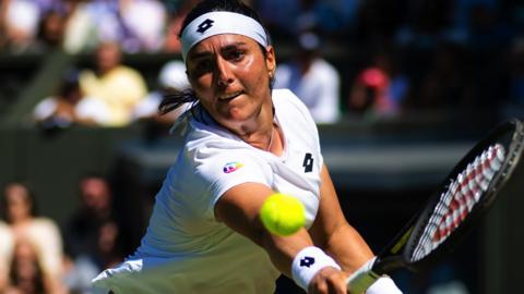 Ons Jabeur plays a backhand at Wimbledon