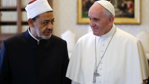 Sheikh al Tayib and Pope Francis stand side by side and look like they are in conversation