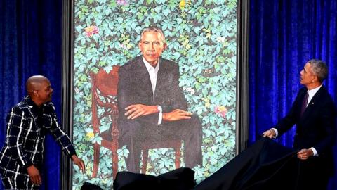 Barack Obama (R) and artist Kehinde Wiley unveil his portrait during a ceremony at the Smithsonian's National Portrait Gallery