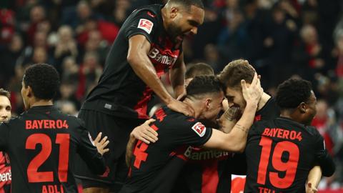 Bayer Leverkusen's players celebrate Josip Stanisic's opening goal